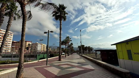 Coastal-boulevard-walkway-lined-with-palm-trees-and-hotels-in-Malaga---Spain