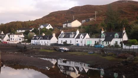 reflection-of-quaint-white-cottage-in-a-little-seaside-village-of-Isle-of-Skye,-hIghlands-of-Scotland