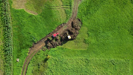 Aerial-View-Of-Excavator-Digging-Soil-On-Field-In-Zas,-A-Coruna,-Spain