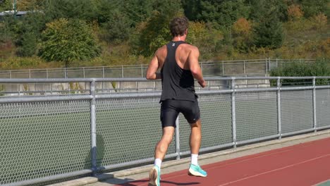 Sprinter-Man-Training-On-Athletics-Track-And-Field-Stadium-During-Summer