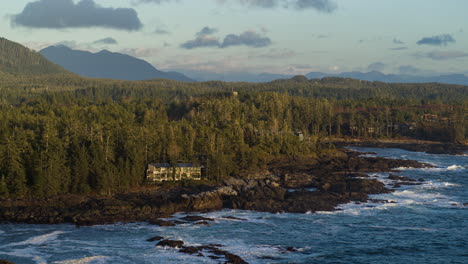 Drone-video-at-sunset-in-Ucluelet-British-Columbia,-Canada-over-the-ocean-and-forest