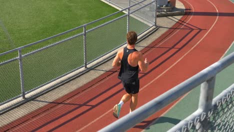 Man-Jogging-On-The-Running-Track---Tracking-Shot