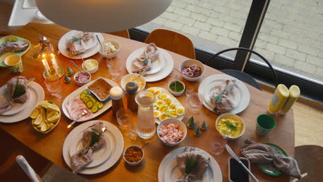 Elegantly-set-table-with-a-spread-of-Scandinavian-dishes,-ready-for-a-feast