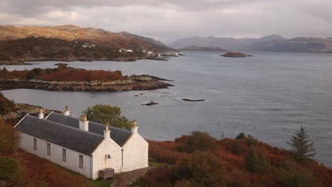 idyllic-white-cottage-on-scenic-islands-of-Isle-of-Skye,-hIghlands-of-Scotland