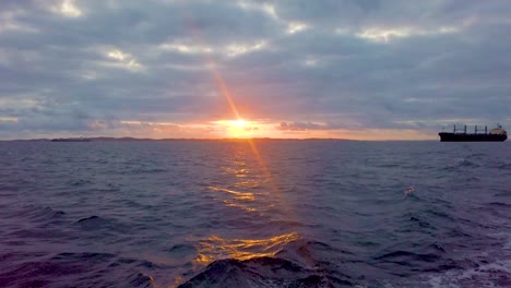 Golden-hour-over-the-sea-in-video,-sunset-is-reflected-in-the-ocean