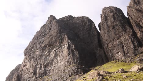 looking-up-at-the-black-cliff-faces-of-Old-Man-of-Storr-on-Isle-of-Skye,-hIghlands-of-Scotland