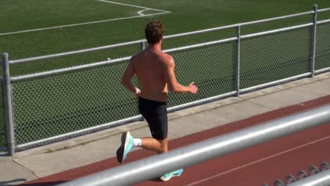 Slow-Motion-Of-A-Shirtless-Guy-With-Muscular-Body-Running-On-A-Sports-Track