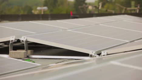 Close-up-panning-shot-of-solar-panels-on-a-rooftop-with-soft-lighting