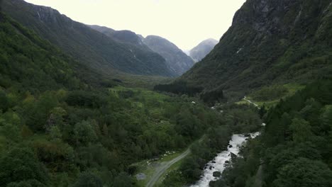 Drone-flies-through-a-mystical-Norwegian-valley-where-a-stream-flows-through