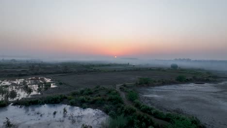 Sunrise-over-tranquil-Sindh-village,-Pakistan---aerial