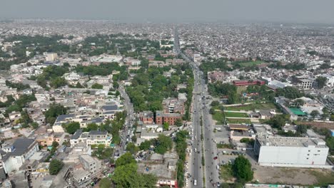Parallax-aerial-view-of-Gujranwala-city-during-daytime-in-Punjab,-Pakistan