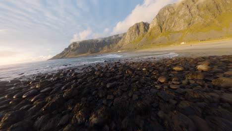 Flying-towards-the-surfer-beach-of-Unstad-Lofoten-Islands-in-Norway,-impressive-low-Cinematic-FPV-drone-flight