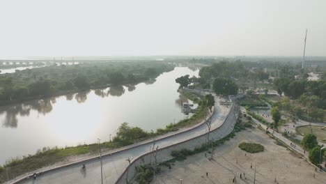 Curved-road-along-Indus-River,-Sukkur,-Sindh---aerial