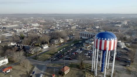Bowling-Green,-Kentucky-downtown-with-drone-video-moving-in-past-water-tower