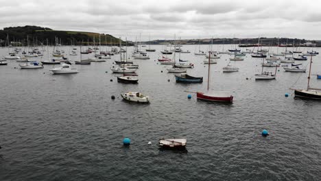 Aerial-forward-shot-flying-over-moored-boat-in-Falmouth-Harbour-Cornwall