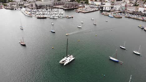 Aerial-View-Yacht-Sailing-Across-Falmouth-Harbour