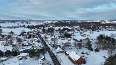 Winter-snow-in-rising-aerial-with-neighborhood-community-in-New-England-USA