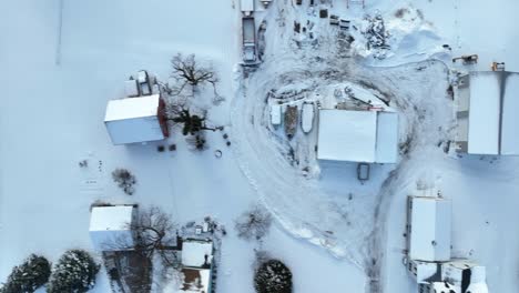 Top-down-aerial-of-rooftops-covered-in-white-winter-snow