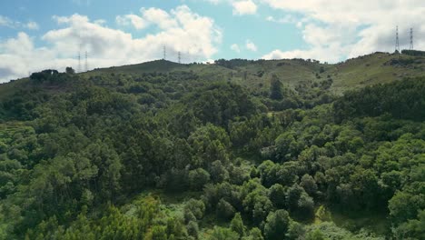 Aerial-Drone-Shot-of-Forest-Landscape-in-Serra-da-Cabreira-and-Gerês,-Alto-Minho,-with-Electric-High-Current-Cables-in-the-Background