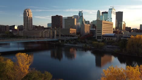 Drone-boom-rise-over-downtown-Minneapolis-from-Nicollet-Island-during-Fall-Golden-Hour-4k