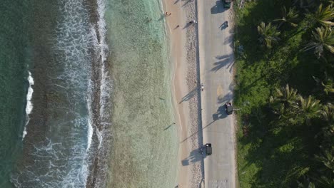 Aerial-View-Ocean-Waves-and-Road-Next-to-Caribbean-Beach