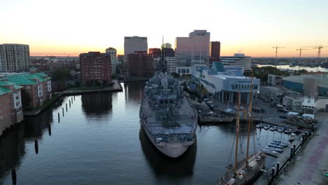 Nauticus-waterfront-maritime-museum-with-USS-Wisconsin-BB-64-on-Elizabeth-River-in-Norfolk,-Virginia