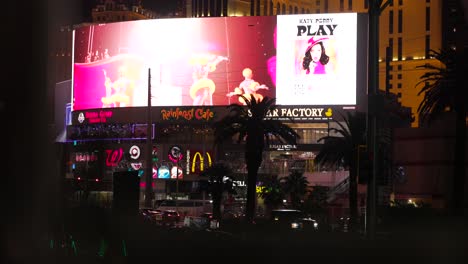Colorful-electronic-billboard-at-night-on-busy-Las-Vegas-street-advertising-concert