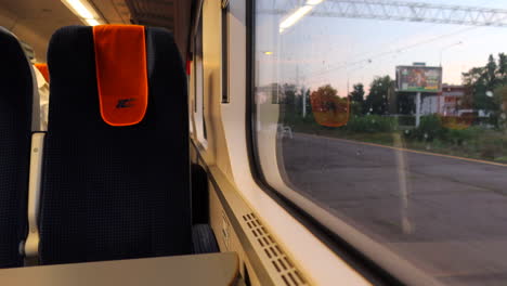 Empty-InterCity-train-seat-inside-an-IC-train-in-Poland,-fast-moving-train,-public-transport,-4K-shot