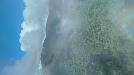 Aerial-Fly-Over-into-Clouds-with-Wide-Area-Mountains-with-Evergreen-Dense-Forest,-Chiang-Mai-Doi-Suthep-National-Park,-Protected-Area-Species-Habitat,-Vertical-Portrait-Video-in-4k