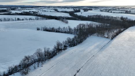 Wide-expanse-of-rural-farmland-covered-in-winter-snow-in-Pennsylvania-USA