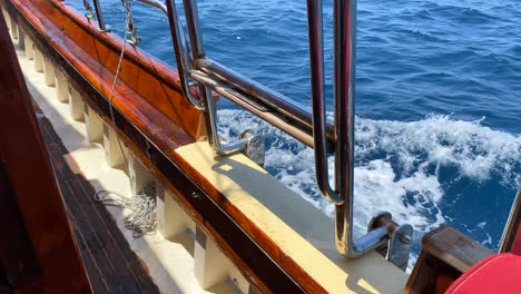 Wooden-deck-on-a-big-sailing-boat-and-sea-waves-in-Bodrum-Turkey,-fun-summer-vacation,-moving-boat,-luxury-holiday-destination,-4K-shot