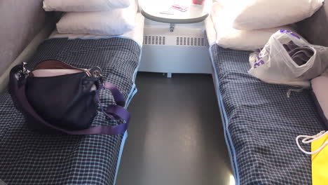 A-train-coupe-for-two-people-on-Ukrainian-Railways-Ukrzaliznycia-East-Europe,-sleeper-train-with-two-beds,-pillows-and-sheets,-traveling-in-comfort-to-Kyiv-Ukraine,-sleeping-on-a-long-train-ride,-4K