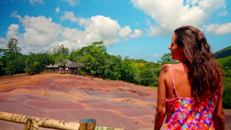 Back-shot-of-young-girl-with-colorful-dress-enjoying-the-view-of-the-Seven-Colored-Earths-in-Chamarel-in-the-Mauritius-island