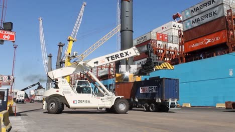 Busy-commercial-port-with-container-trucks-and-cranes,-blue-sky-at-port-of-Buenos-Aires,-timelapse