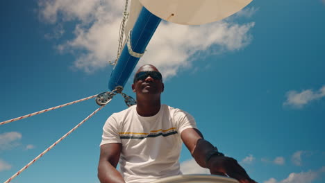 African-captain-driving-a-catamaran