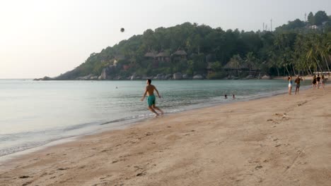 Man-on-Sairee-beach-exuberantly-plays-with-his-ball-during-his-vacation
