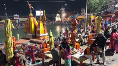 pov-shot-Many-people-are-having-darshan-of-Ganga-Aarti-and-its-prasad-is-being-seen-and-many-people-are-having-darshan