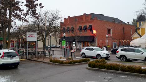 Scenic-street-scene-of-historic-Hyde-Park,-Boise's-North-End-with-shops,-restaurants-and-cafes-during-light-snowfall-in-wintery-fall-season