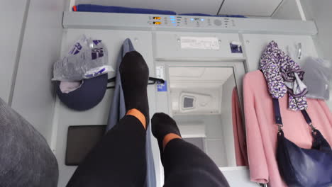 Funny-feet-in-a-train-coupe-on-Ukrainian-Railways-Ukrzaliznycia-East-Europe,-sleeper-train-with-two-beds-and-sheets,-traveling-in-comfort-to-Kyiv-Ukraine,-sleeping-on-a-long-train-ride,-4K-shot