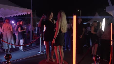 Slow-dolly-shot-of-people-dancing-on-a-360-camera-stage-at-a-corporate-party