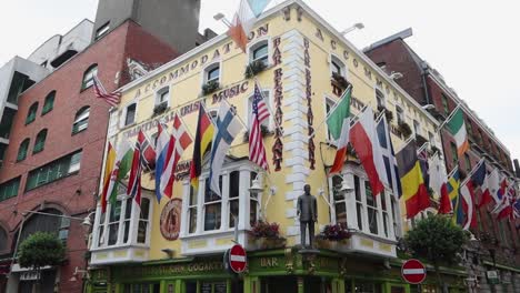 Old-building-facade-decorated-with-different-national-flags-in-Dublin