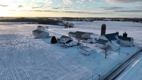 American-family-farm-in-white-winter-snow-at-sunrise