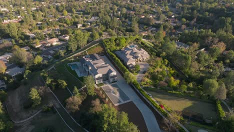 Drone-Shot-Hovering-Above-Upscale-Mansion-in-Leafy-Green-Gated-Community-of-Hidden-Hills,-Calabasas,-California-at-Golden-Hour