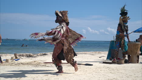 Slow-motion-of-a-mayan-eagle-warrior-from-a-dance-company-that-performs-on-the-mayan-riviera-and-cancun-beaches-for-the-tourists