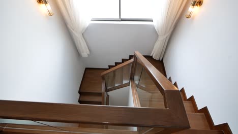 Schöne-Und-Saubere,-Glänzende-Holztreppe-Und-Weiße-Wand