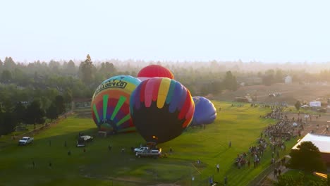 Hot-air-balloons-inflating-at-sunset-during-the-Balloons-Over-Bend-event-in-Bend,-Oregon