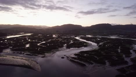 Sunset-over-dramatic-tidal-coastal-flood-valley-ria-habitat-Spain-AERIAL