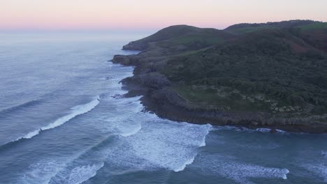 Spain's-Cantabrian-rugged-coast-as-sun-sets-over-Bay-of-Biscay-AERIAL-4K