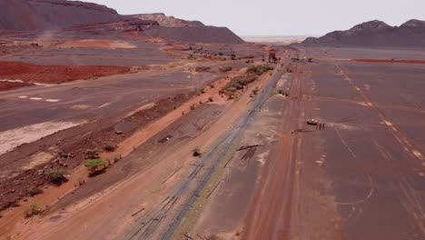Drone-shot-capturing-the-mine-and-train-tracks-in-Zouérat,-Mauritania
