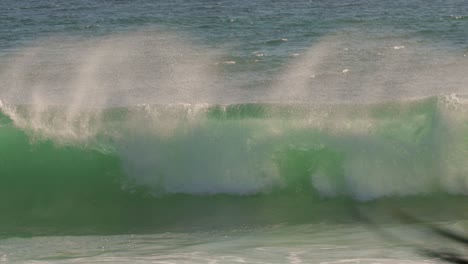 Surfer-duck-diving-under-a-wave-the-waves-on-a-sunny-day,-Burleigh-Heads,-Gold-Coast,-Australia